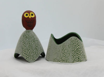 Ceramic trinket holder with a brown on top.