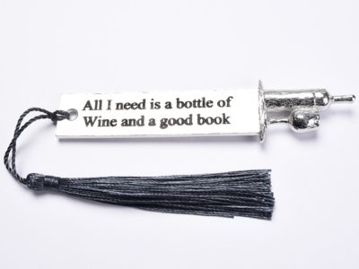 Pewter metal bookmark with the quotation 'All I need is a bottle of wine and a good book' A bottle and glass sculpture sit on the top.