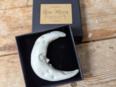 porcelain moon: art sculpture crescent moon with a face. Man in the moon