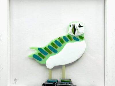 Puffin on rocks, green/blue striped, in frame